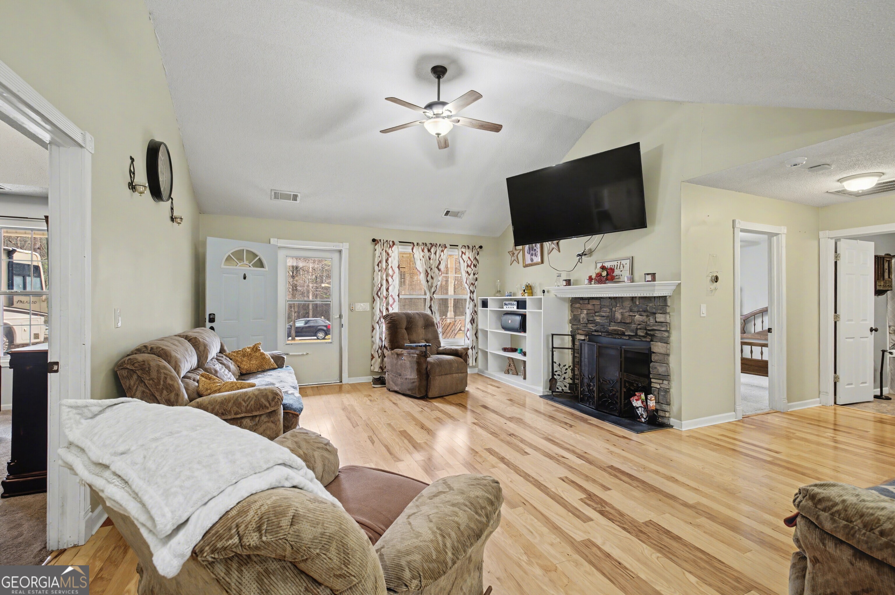 183 Buck Smith Road Hogansville, GA 30230 - Photo 6 of 28 a living room with furniture a flat screen tv and a fireplace
