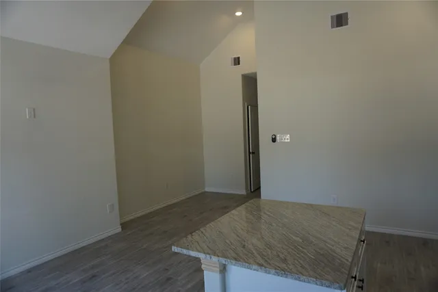 a kitchen with stainless steel appliances granite countertop a sink stove and cabinets