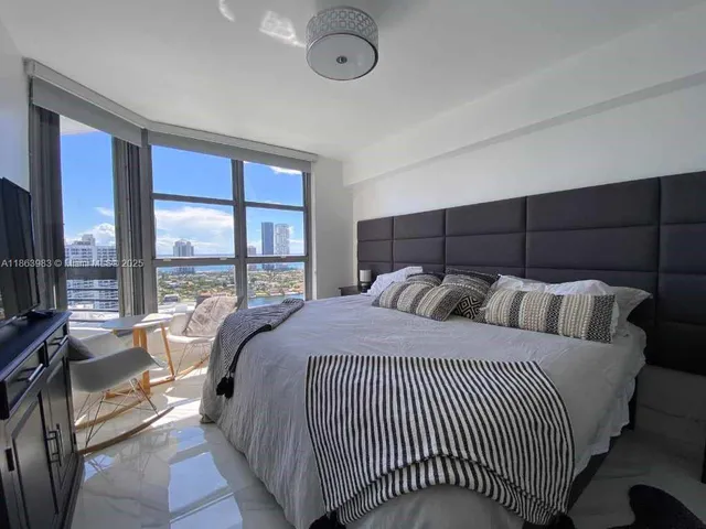 a bed sitting in a bedroom next to a large window