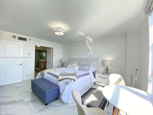 a bedroom with a bed and chandelier