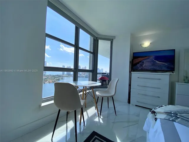 a view of a dining room with furniture and a window