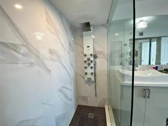 a bathroom with a shower and a sink
