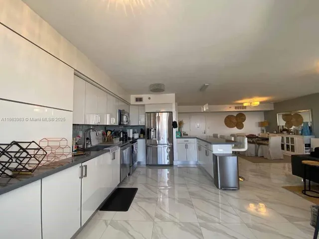 a kitchen with lots of counter top space and appliances