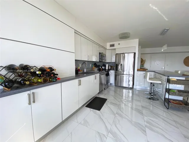 a kitchen with stainless steel appliances a refrigerator and a sink