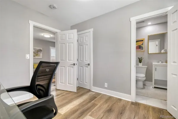 a living room with furniture and view of kitchen