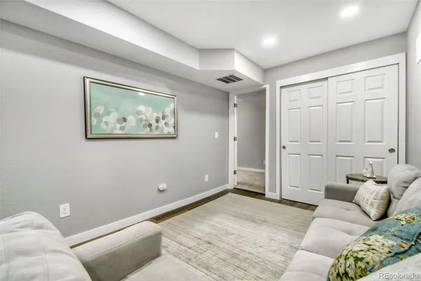 a bedroom with a bed and painting on the wall