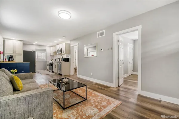 a living room with furniture and kitchen view