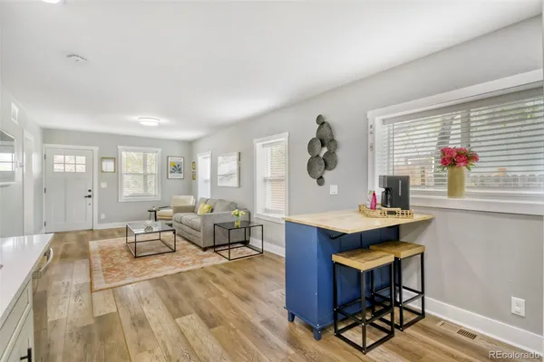 a kitchen with stainless steel appliances granite countertop a refrigerator a sink and a stove