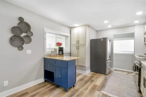 a kitchen with stainless steel appliances granite countertop a stove top oven a sink and dishwasher a refrigerator with wooden cabinets