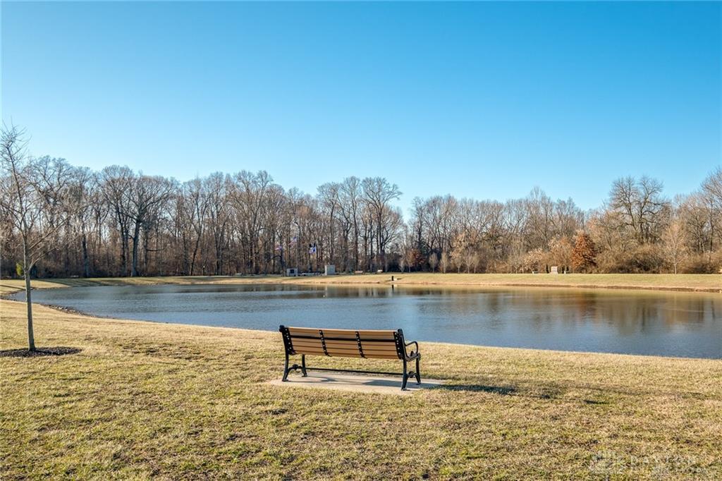 407 Brownstone Row Springboro, OH 45066 - Photo 52 of 54 Find tranquility by the serene pond, perfect for peaceful reflection and outdoor enjoyment.