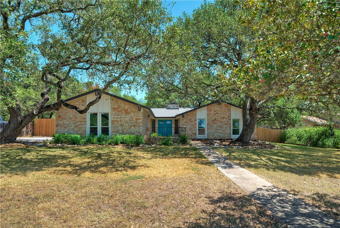 8701 El Rey Boulevard Austin, TX 78737 - Photo 1 of 1 a house with a tree in front of it