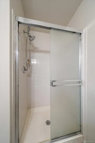 a bathroom with a glass shower door