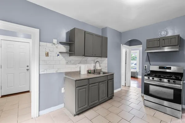 a kitchen with stainless steel appliances a stove sink and cabinets