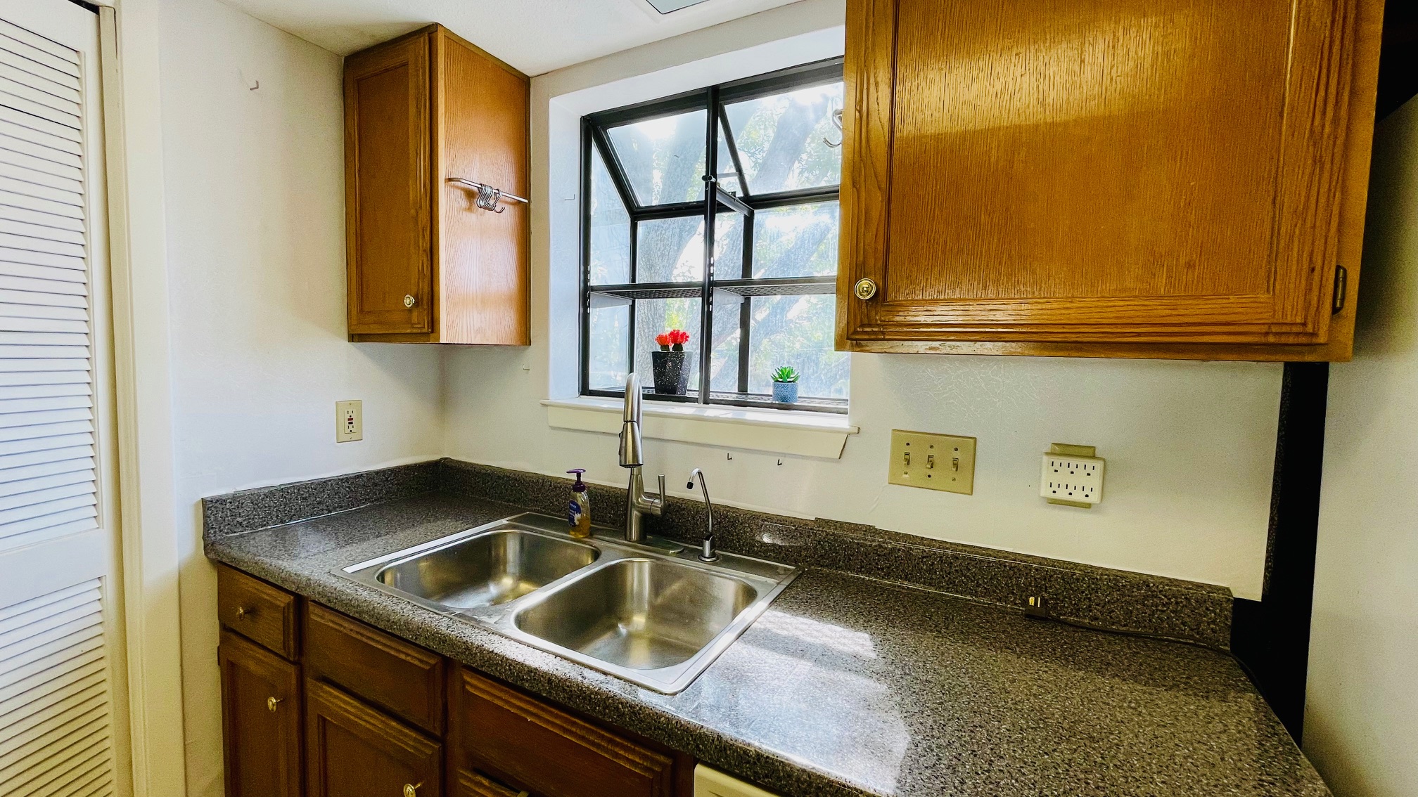 1510 West N Loop Boulevard, Unit 822 Austin, TX 78756 - Photo 6 of 12 Kitchen with dark countertops and wood finish cabinets