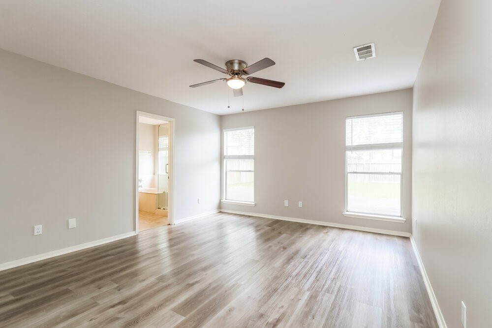 2711 Knollbrook Lane Spring, TX 77373 - Photo 12 of 17 an empty room with wooden floor and windows