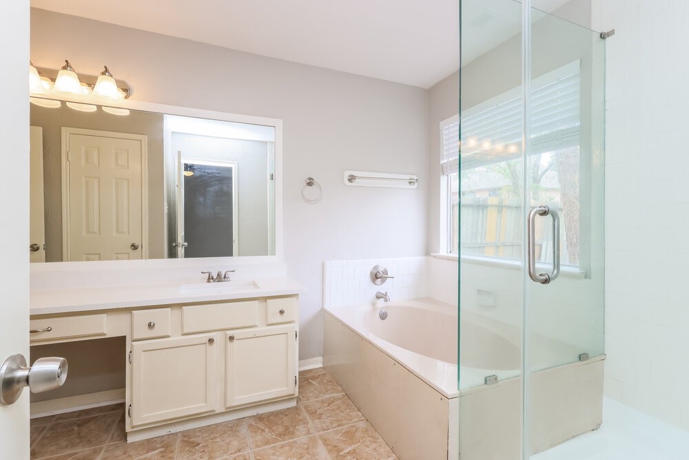2711 Knollbrook Lane Spring, TX 77373 - Photo 13 of 17 a bathroom with a bathtub sink and mirror