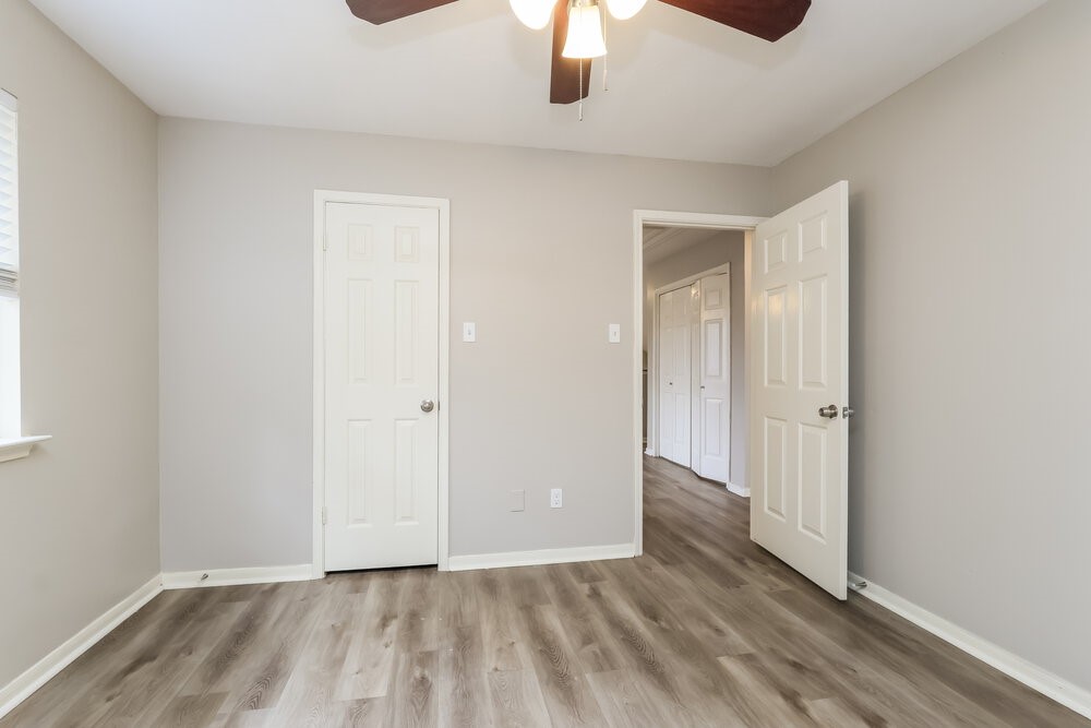 2711 Knollbrook Lane Spring, TX 77373 - Photo 15 of 17 an empty room with wooden floor chandelier fan and closet area