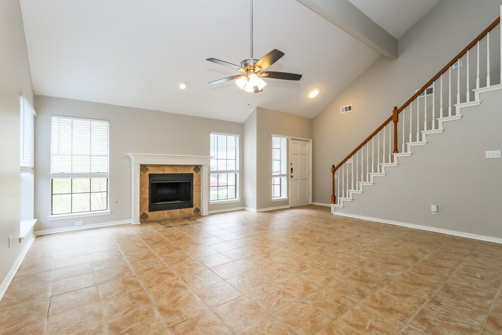 2711 Knollbrook Lane Spring, TX 77373 - Photo 5 of 17 a view of an empty room with chandelier fan and a fireplace