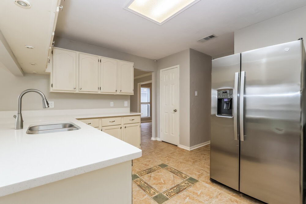 2711 Knollbrook Lane Spring, TX 77373 - Photo 9 of 17 a kitchen with a refrigerator sink and cabinets