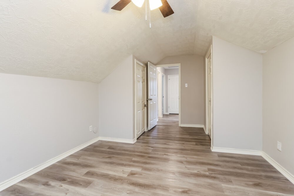 2711 Knollbrook Lane Spring, TX 77373 - Photo 10 of 17 a view of a room with wooden floor and a ceiling fan