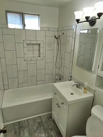 a bathroom with a bathtub a sink and a shower
