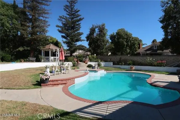 a view of a swimming pool with lounge chairs
