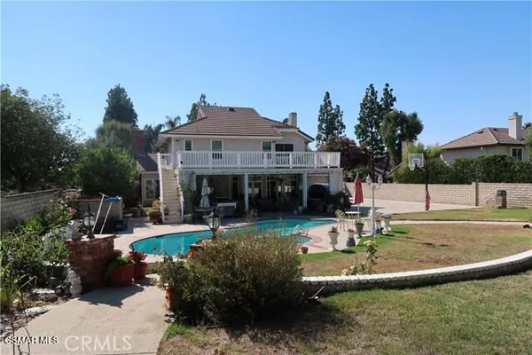 a view of a house with a garden and swimming pool