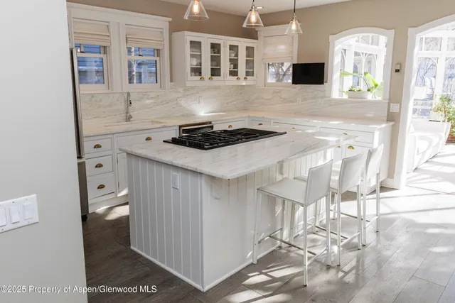 a kitchen with stainless steel appliances a stove a sink and a refrigerator