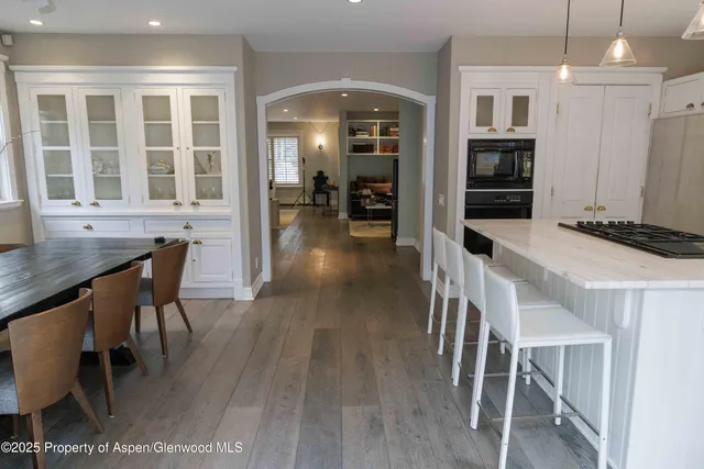 a dining room with furniture and wooden floor