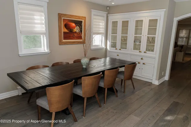 a view of a dining room with furniture and wooden floor
