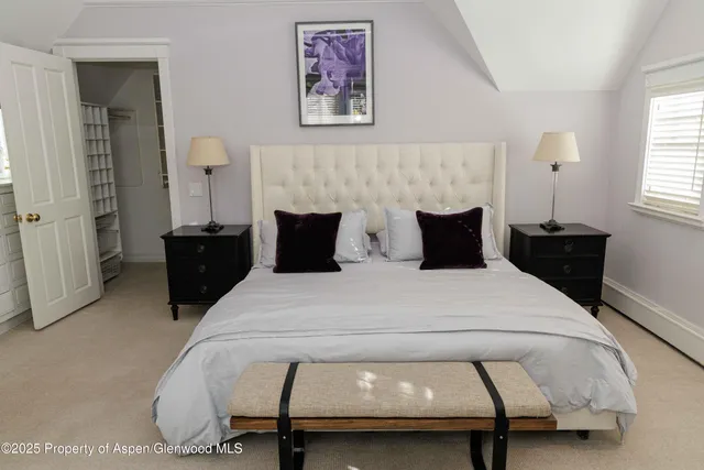 a bedroom with furniture and a window