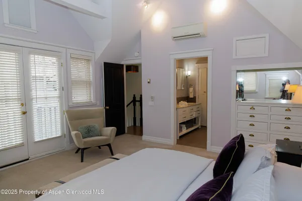 a bedroom with a bed and a lamp