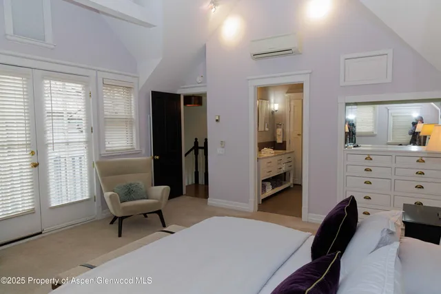 a bedroom with a bed and a lamp