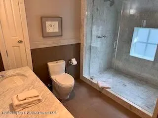 a bedroom with a bed and a lamp on table