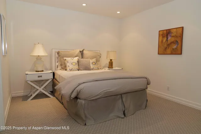 a bedroom with a bed and a night stand