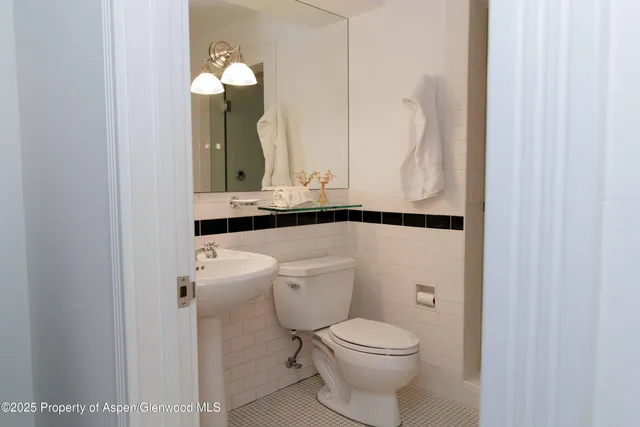 a bedroom with a bed and a lamp