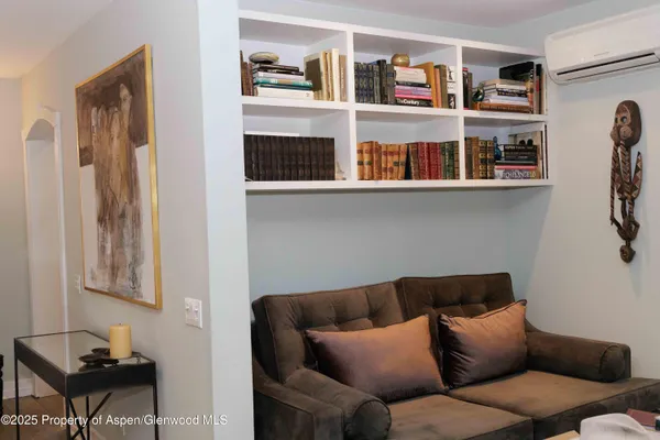 a living room with furniture cabinets and a window