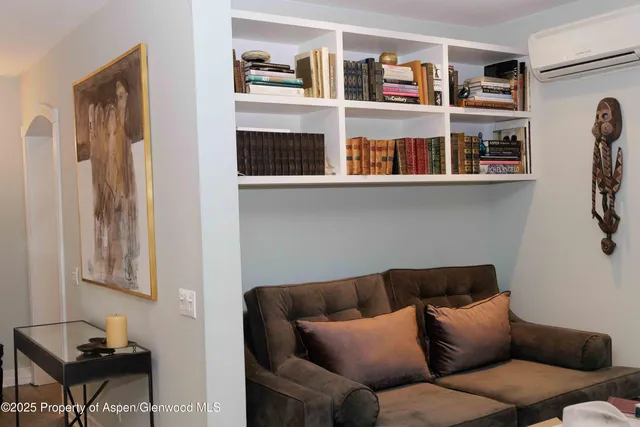 a living room with furniture cabinets and a window