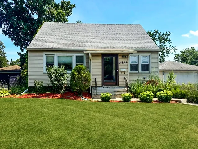 a front view of a house with a yard and porch