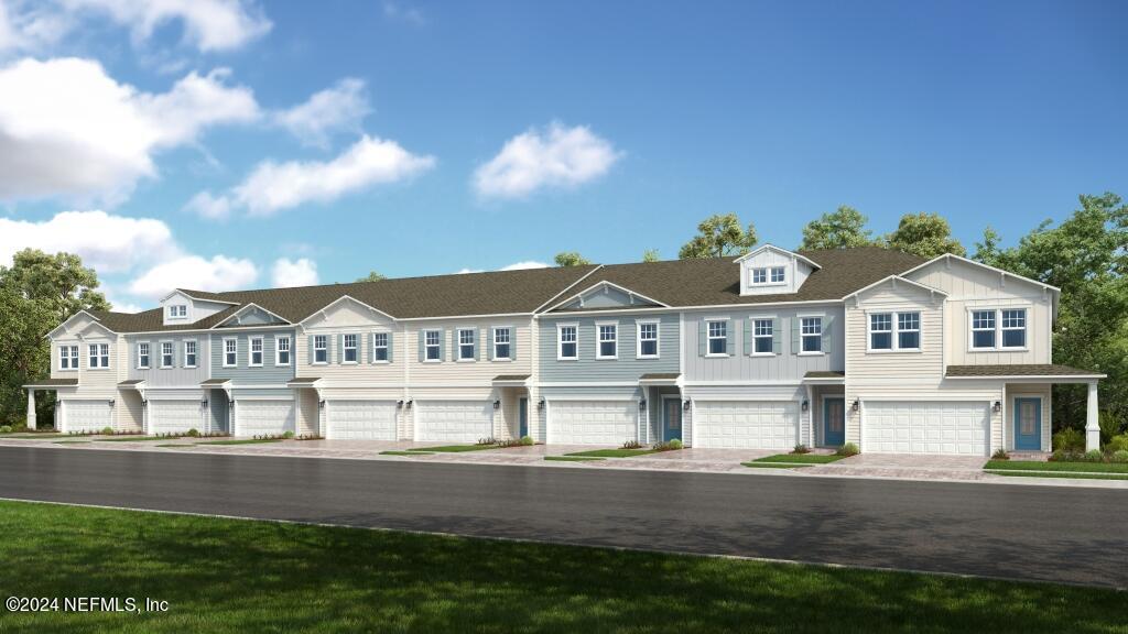 a front view of a house with a garden and lake view
