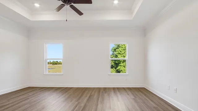 a view of a room with a window and wooden floor