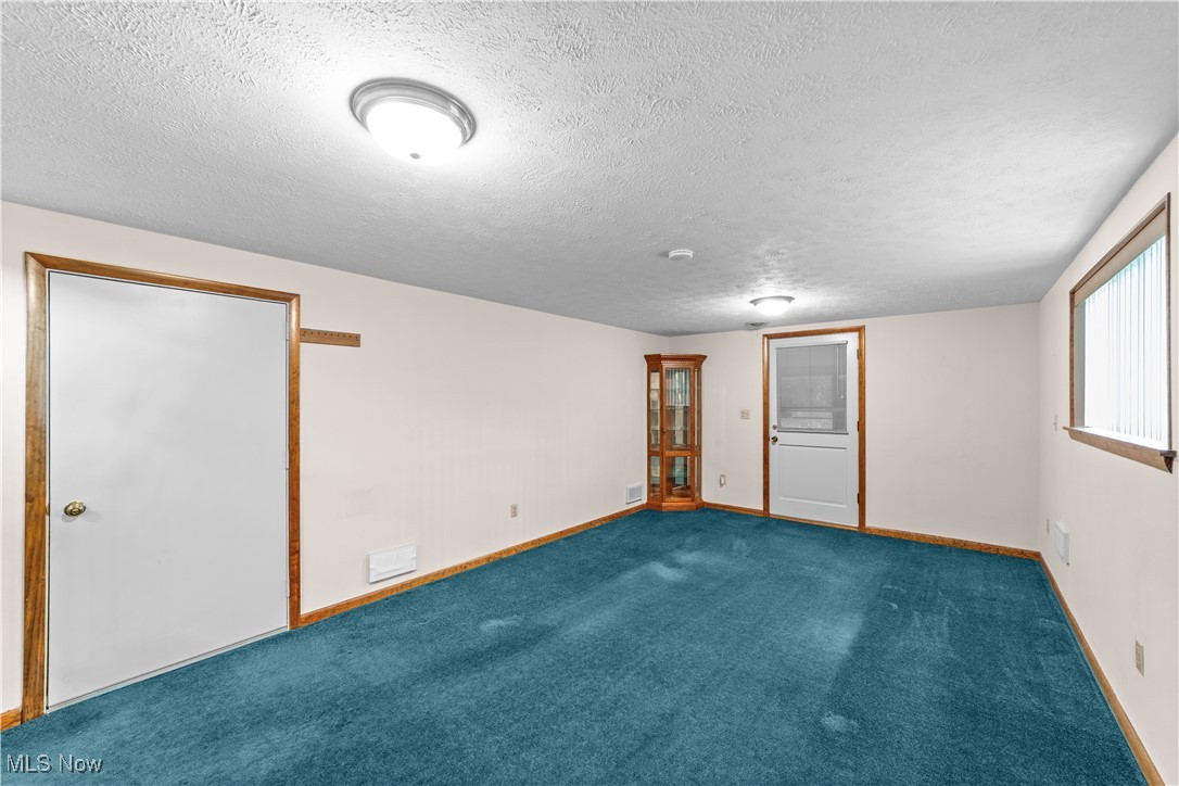 648 Rehwinkle Road Northfield, OH 44067 - Photo 8 of 38 Unfurnished room featuring a textured ceiling and carpet flooring