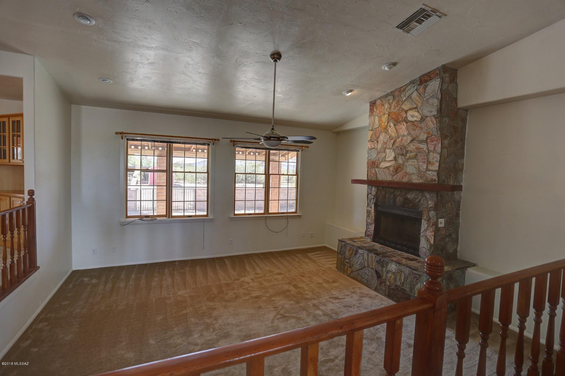 5851 South Avra Road Tucson, AZ 85735 - Photo 9 of 46 a living room with furniture and a fireplace