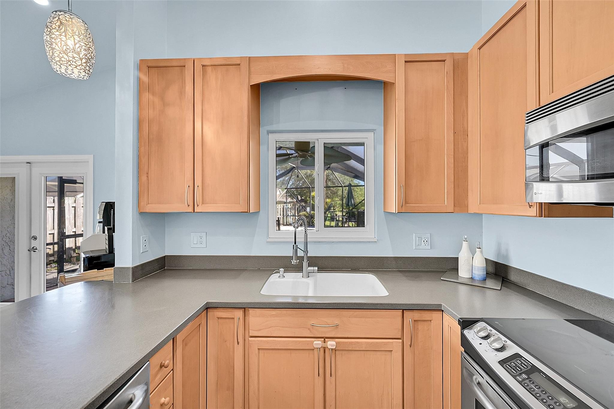 22533 Swordfish Drive Boca Raton, FL 33428 - Photo 13 of 49 a kitchen with stainless steel appliances a sink a stove cabinets and a counter top space