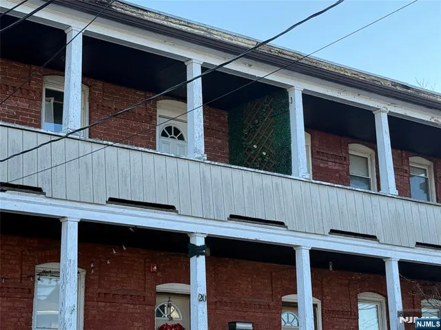 a view of a house with wooden deck