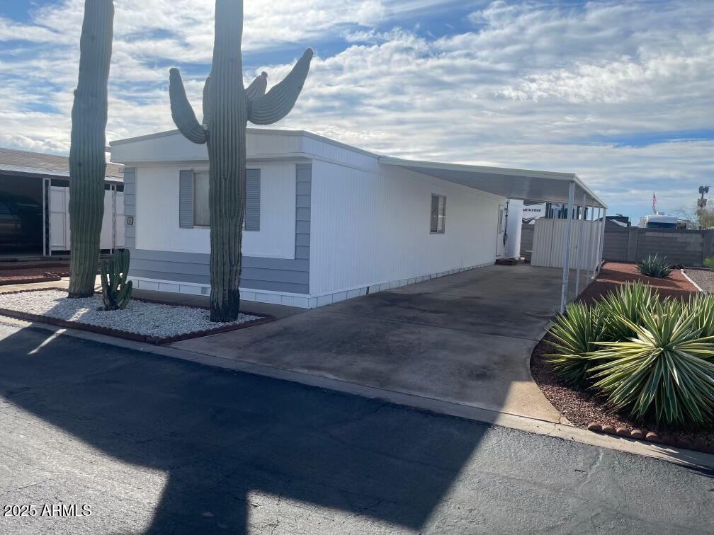 2605 South Tomahawk Road, Unit 8 Apache Junction, AZ 85119 - Photo 1 of 21 a backyard of a house with table and chairs