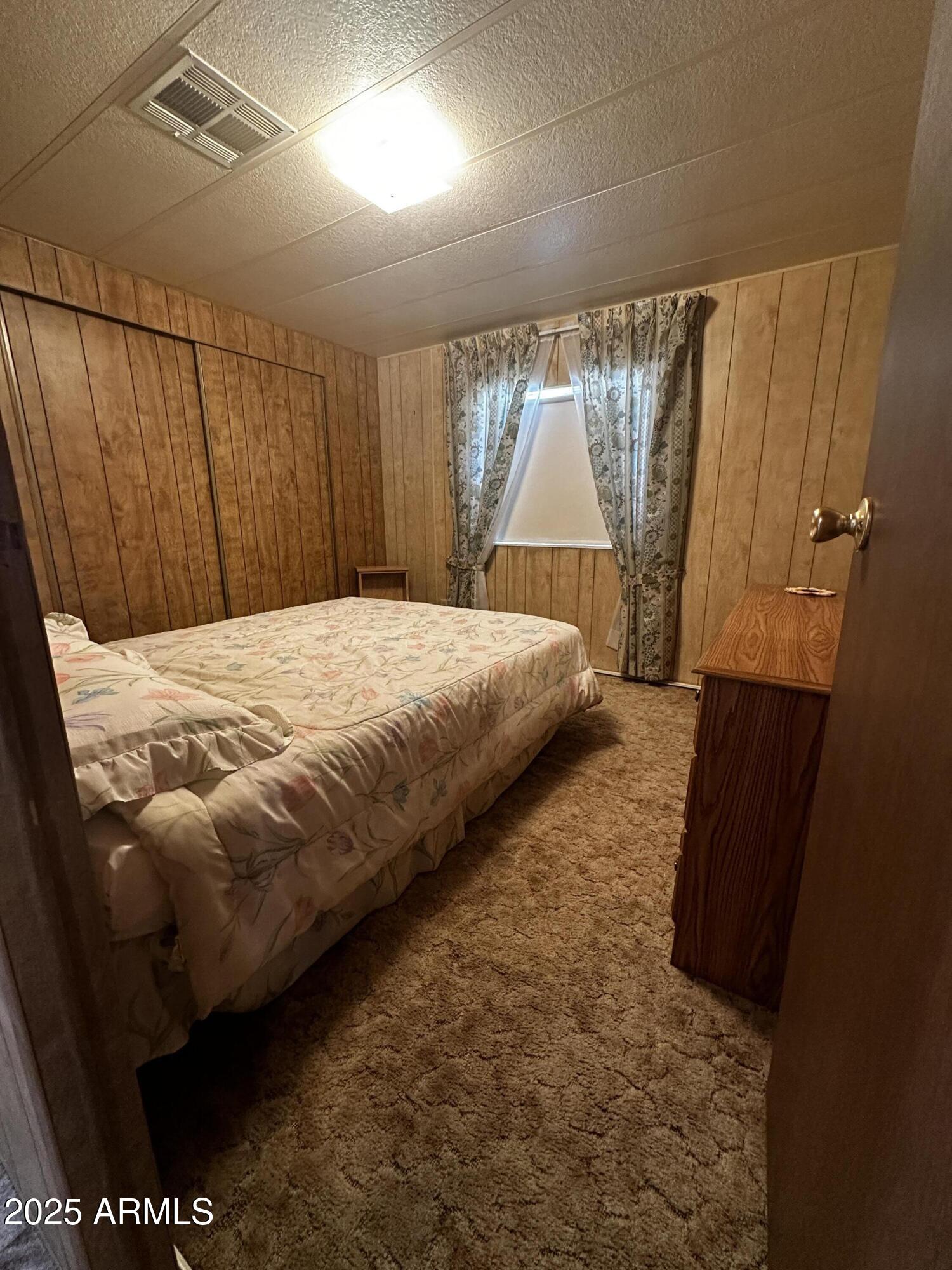 2605 South Tomahawk Road, Unit 8 Apache Junction, AZ 85119 - Photo 11 of 21 a bedroom with a bed and a window