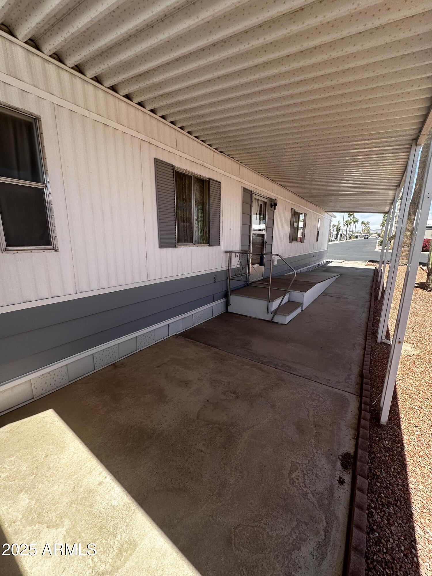 2605 South Tomahawk Road, Unit 8 Apache Junction, AZ 85119 - Photo 16 of 21 a roof deck with table and chairs