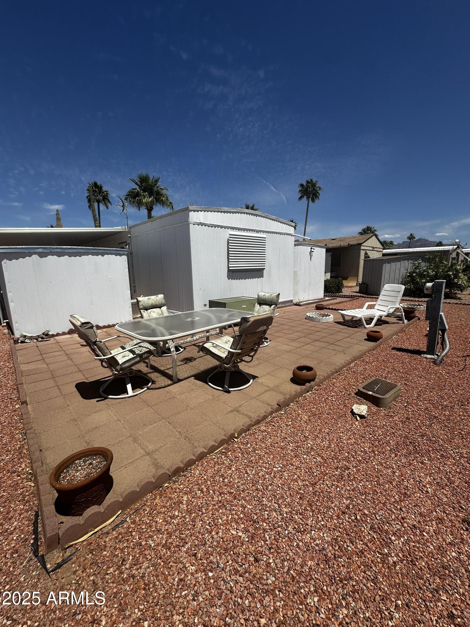 2605 South Tomahawk Road, Unit 8 Apache Junction, AZ 85119 - Photo 18 of 21 a room with furniture and a flat screen tv