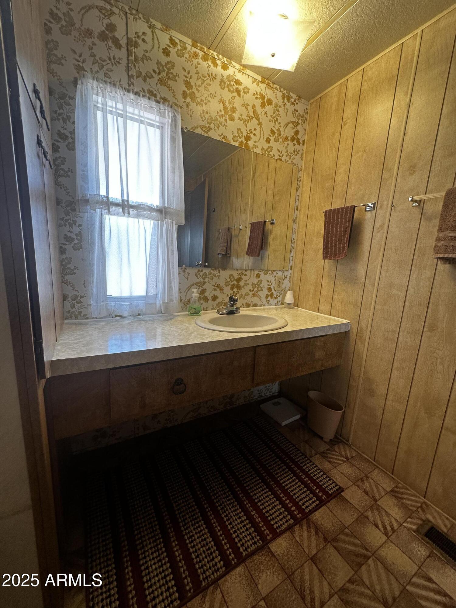 2605 South Tomahawk Road, Unit 8 Apache Junction, AZ 85119 - Photo 9 of 21 a bathroom with a sink and a mirror